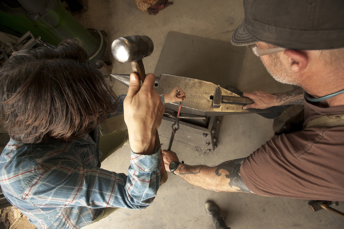 Tina Larkin Kate Czark works on her project with guest blacksmithing instructor Hunter Dahlberg.